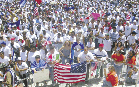 Romie Dela Paz, NaFFAA Florida Chairman gestures as Sister Ann Kendrick of the Farmworker Ministry look on at the assembled marchers.